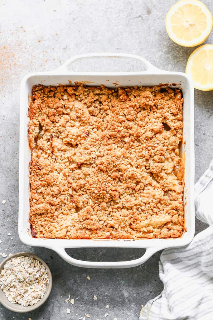 A baking dish with baked apple crisp in it, hot from the oven.