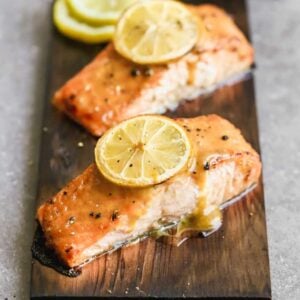 Two salmon filets cooked on a cedar plank.