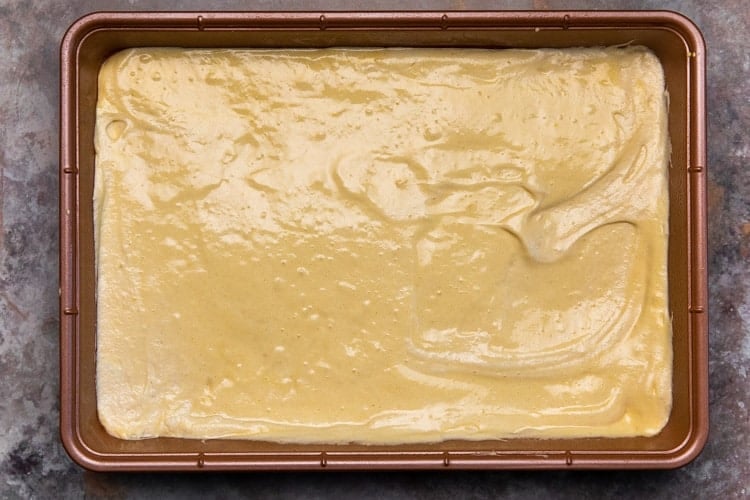 Cake batter smoothed into a 9x13 inch baking pan.